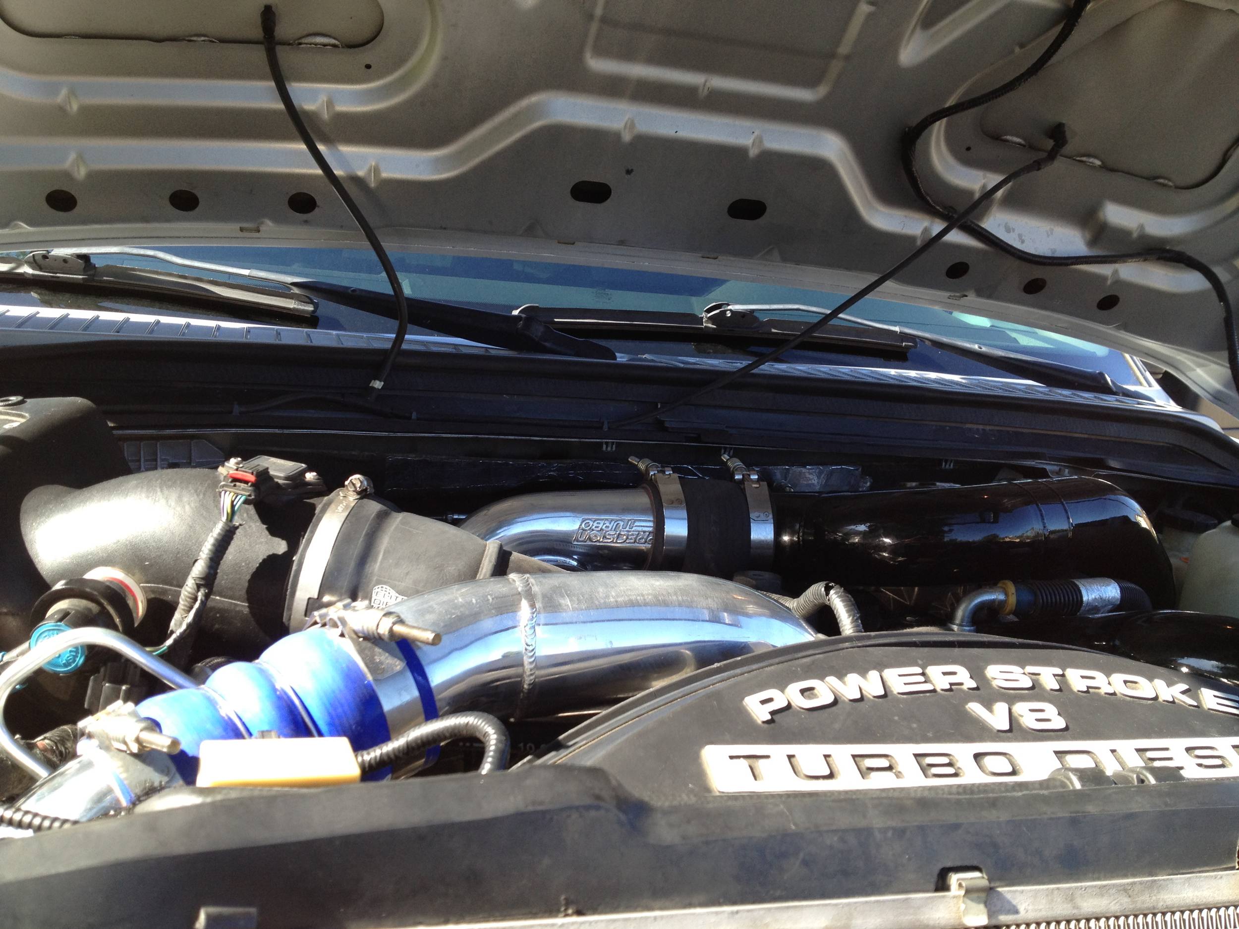 silver_truck_under_hood_dual_pumps